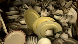 A jumbled pile of dusty broken plates