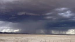 Rain falling in distance from storm clouds over the plain